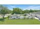 Well-maintained lawn and fenced yard featuring an additional outdoor building and patio area, with some solar panels at 1325 Mcneil Rd, Altamonte Springs, FL 32714