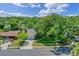 Aerial view showcases the home's curb appeal, mature trees, and well-manicured lawn at 1440 Suzanne Way, Longwood, FL 32779