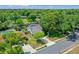 Aerial view of the home showcases its location, pool, mature trees, and neighborhood at 1440 Suzanne Way, Longwood, FL 32779