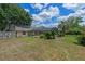 A large grassy backyard features an enclosed pool and a well maintained lawn at 1440 Suzanne Way, Longwood, FL 32779