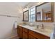 Bright bathroom featuring a double vanity, two mirrors, ample lighting, and a window offering natural light at 1440 Suzanne Way, Longwood, FL 32779