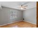 Bedroom with hardwood floors, a ceiling fan, a window, and neutral-colored walls at 1440 Suzanne Way, Longwood, FL 32779