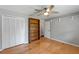 Bedroom with hardwood floors, a ceiling fan, a closet, and a bookcase at 1440 Suzanne Way, Longwood, FL 32779
