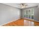 Bedroom with hardwood floors, a ceiling fan, a window with shutters, and neutral-colored walls at 1440 Suzanne Way, Longwood, FL 32779