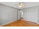 Bedroom with hardwood floors, a closet, and neutral-colored walls at 1440 Suzanne Way, Longwood, FL 32779