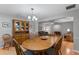 An expansive dining room includes a wooden table, hardwood floors, and a decorative china cabinet at 1440 Suzanne Way, Longwood, FL 32779