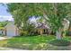 Charming home boasts lush landscaping, mature trees, and a well-manicured lawn, adding to its curb appeal at 1440 Suzanne Way, Longwood, FL 32779