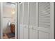Hallway leading to a bathroom with a double vanity and a three-door closet at 1440 Suzanne Way, Longwood, FL 32779