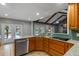 This remodeled kitchen overlooks the pool with granite counters, custom wood cabinets, and tiled floors at 1440 Suzanne Way, Longwood, FL 32779