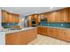 This kitchen features granite counters, tiled floors, and stainless steel appliances with wood cabinets at 1440 Suzanne Way, Longwood, FL 32779