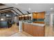 Open-concept kitchen featuring granite countertops and an island with a breakfast bar flows into the living area at 1440 Suzanne Way, Longwood, FL 32779