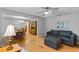 Bright, open-concept living area features hardwood floors, a comfortable seating area, and a dining space at 1440 Suzanne Way, Longwood, FL 32779