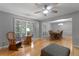 A well-lit living room showcases hardwood floors, neutral paint, and plantation shutters for added charm at 1440 Suzanne Way, Longwood, FL 32779