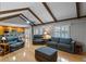Spacious living room showcases vaulted ceilings, exposed beams, wood floors, and an open kitchen concept at 1440 Suzanne Way, Longwood, FL 32779