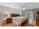 The main bedroom features hardwood floors, a ceiling fan, and French doors that lead to the backyard at 1440 Suzanne Way, Longwood, FL 32779