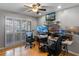Home office with hardwood floors, a ceiling fan, a window with shutters, and multiple computer monitors at 1440 Suzanne Way, Longwood, FL 32779