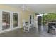 Screened in patio with rocking chairs, tiled floors, and access to the backyard at 1440 Suzanne Way, Longwood, FL 32779