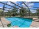 Enclosed pool with tile accents and brick paved deck offers a refreshing outdoor space at 1440 Suzanne Way, Longwood, FL 32779