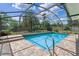 Inviting screened-in pool area features brick pavers and clear blue water, perfect for outdoor relaxation at 1440 Suzanne Way, Longwood, FL 32779
