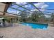Enclosed pool with brick paved deck provides a relaxing outdoor living space at 1440 Suzanne Way, Longwood, FL 32779
