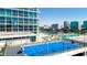 Aerial view of a blue basketball court on a rooftop with a lake and city skyline in the background at 150 E Robinson St # 2807, Orlando, FL 32801