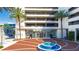 Welcoming building entrance with tiled fountain and palm trees at 150 E Robinson St # 2807, Orlando, FL 32801