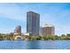 Exterior shot of the high-rise building on the lake with beautiful blue skies at 150 E Robinson St # 2807, Orlando, FL 32801