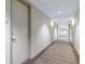 Well-lit hallway with neutral decor leading to residences at 150 E Robinson St # 2807, Orlando, FL 32801