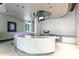 Modern kitchen area featuring a large curved island, stainless steel appliances, and unique lighting at 150 E Robinson St # 2807, Orlando, FL 32801