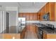 Well-equipped kitchen featuring wooden cabinetry and granite countertops at 150 E Robinson St # 2807, Orlando, FL 32801