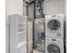 Efficient laundry room with shelving and stacked washer and dryer at 150 E Robinson St # 2807, Orlando, FL 32801