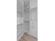 Walk-in closet view featuring hardwood floors and custom shelving at 150 E Robinson St # 2807, Orlando, FL 32801