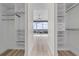 Walk-in closet view with hardwood floors, custom shelving, and a window overlooking the skyline at 150 E Robinson St # 2807, Orlando, FL 32801