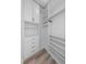 Walk-in closet view featuring hardwood floors, custom shelving, drawers, and closet rods at 150 E Robinson St # 2807, Orlando, FL 32801