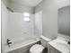Clean white bathroom featuring a bathtub, tiled walls, vanity, and natural light at 1543 Sarah St, Lake Wales, FL 33898