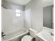 Clean bathroom with tiled walls, a bathtub/shower combination, a toilet and a vanity at 1543 Sarah St, Lake Wales, FL 33898
