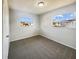 A well-lit bedroom featuring gray carpet, neutral walls, and natural light through two windows at 1543 Sarah St, Lake Wales, FL 33898