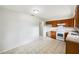 An open view of a kitchen featuring wood cabinets and white appliances at 1543 Sarah St, Lake Wales, FL 33898