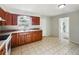 Traditional-style kitchen with wood cabinets, light countertops, and tile flooring at 1543 Sarah St, Lake Wales, FL 33898