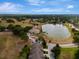 Community aerial view showcasing the beautiful lake, clubhouse, and well-manicured landscaping around the townhouses at 1570 Barking Deer Cv, Casselberry, FL 32707