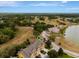 Scenic aerial view highlighting the townhouse's proximity to a serene lake and clubhouse at 1570 Barking Deer Cv, Casselberry, FL 32707