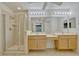 Bright bathroom with double sinks, vanity area, walk-in shower and white cabinetry at 1570 Barking Deer Cv, Casselberry, FL 32707