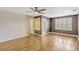 Bright bedroom features hardwood floors, ceiling fan, and windows with plantation shutters at 1570 Barking Deer Cv, Casselberry, FL 32707