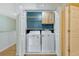 A closet with a washer and dryer hookup and a cabinet above it for laundry supplies at 1570 Barking Deer Cv, Casselberry, FL 32707