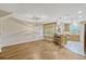 Open-concept living room features stylish lighting, hardwood floors, and a kitchen view at 1570 Barking Deer Cv, Casselberry, FL 32707