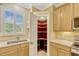 A kitchen features a walk-in pantry, cabinets, and a window at 1570 Barking Deer Cv, Casselberry, FL 32707