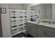 Well-lit bathroom features a double sink vanity and a shower with a patterned curtain at 1596 Park Side Ave, Kissimmee, FL 34744