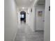 Hallway view with tiled flooring and several arched doorways leading to other rooms at 1596 Park Side Ave, Kissimmee, FL 34744
