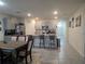 Charming kitchen features a dining area, bar-style seating, stainless appliances, and modern neutral cabinetry at 1596 Park Side Ave, Kissimmee, FL 34744