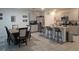Charming kitchen with a dining area, bar-style seating, stainless steel appliances, and neutral cabinetry at 1596 Park Side Ave, Kissimmee, FL 34744